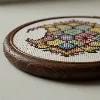 Cross stitch hoop with a vibrant floral pattern