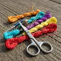 Close-up of cross stitching tools and colorful threads